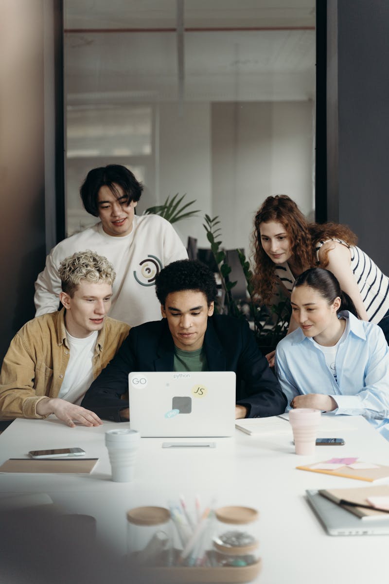Multiracial team collaborating on a project in a modern office setting.